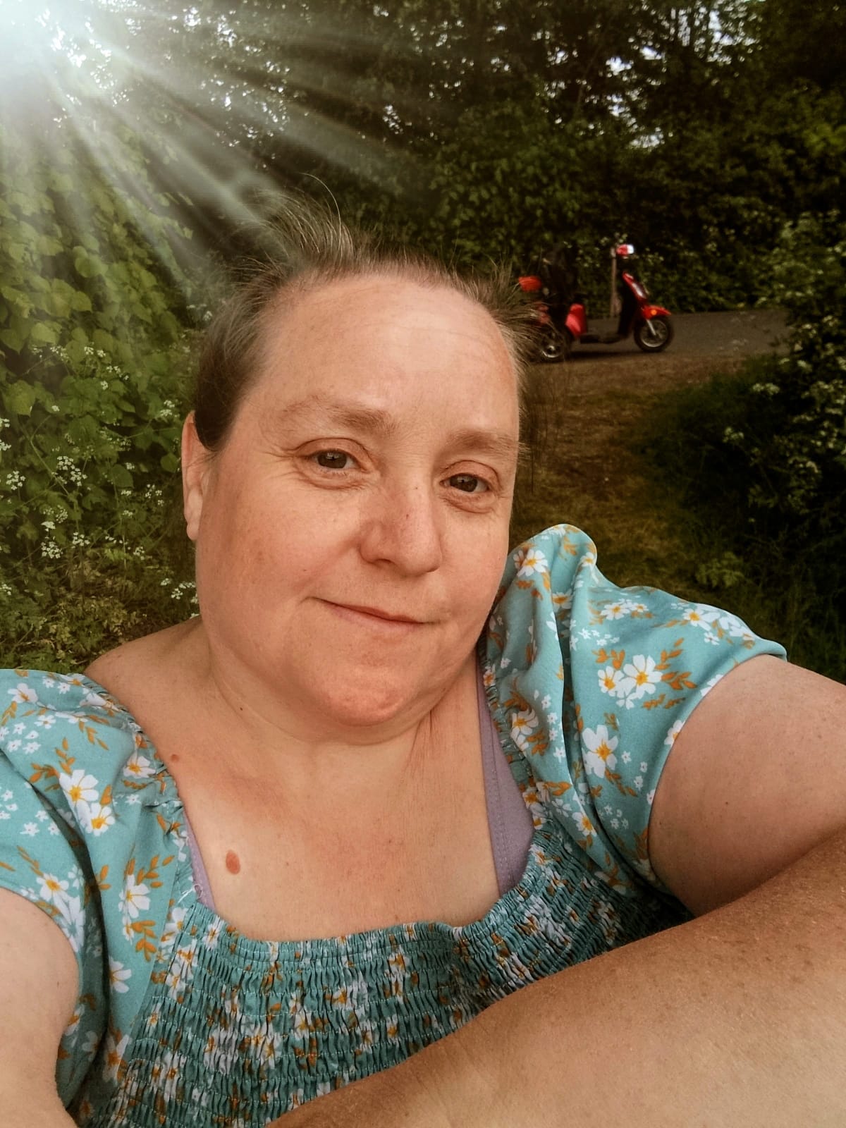 Portrait of therapist Sarah outdoors in soft sunlight